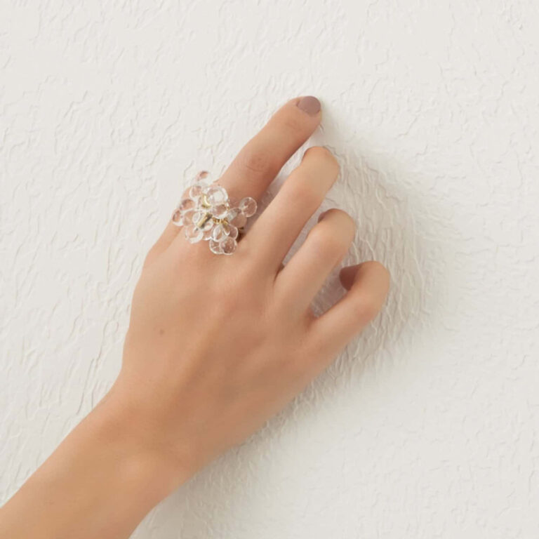 ring with glass spheres worn